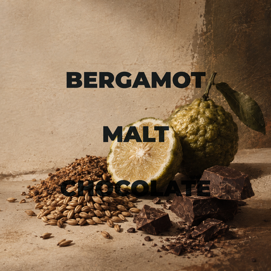 A styled product graphic showing a bergamot fruit, a sliced bergamot, malt grains, and chocolate chunks on a textured beige surface with the text 'BERGAMOT MALT CHOCOLATE' overlaid in large black letters.